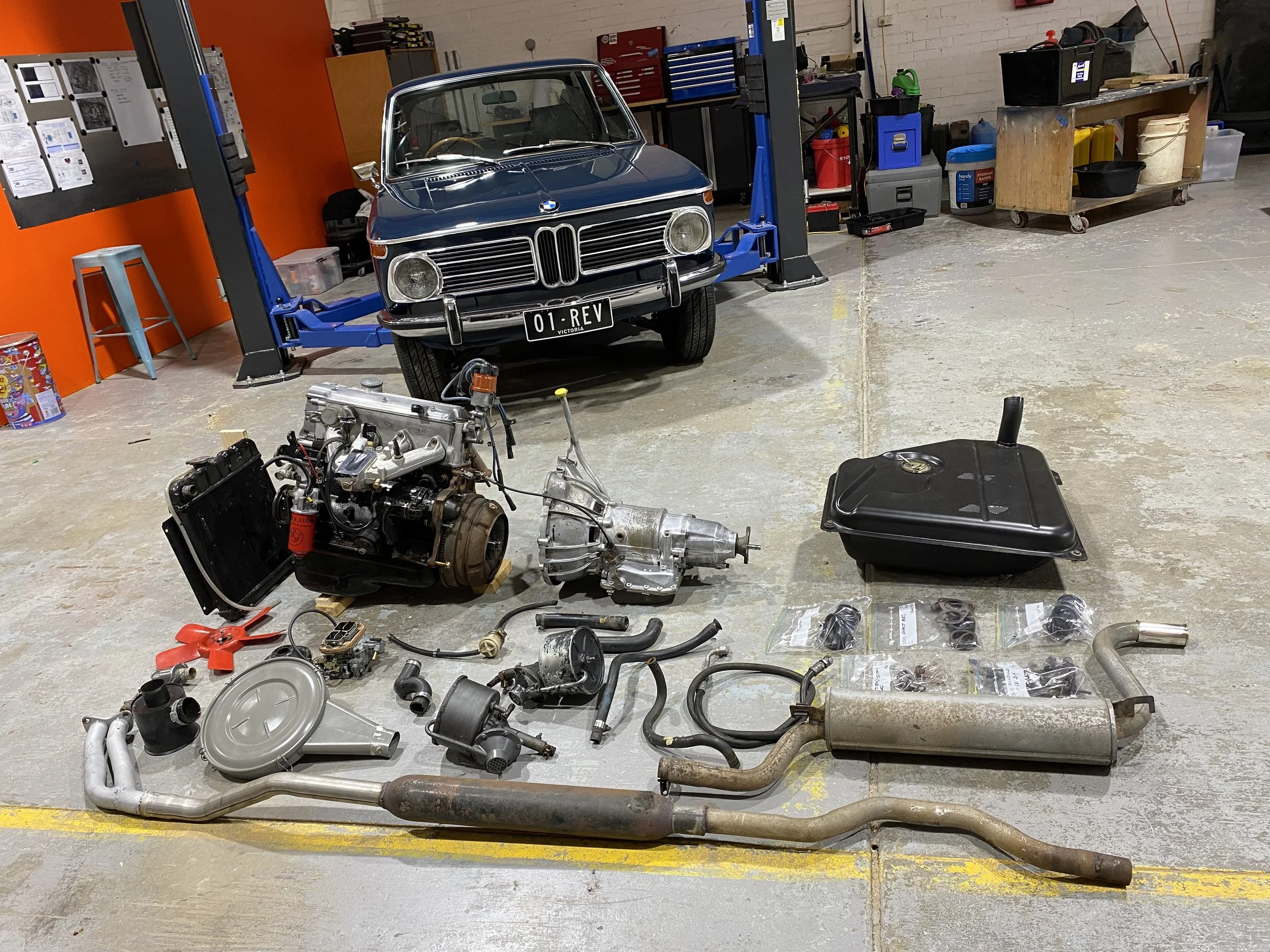 Components removed from the BMW 2002 during EV conversion — approximately 300 kg